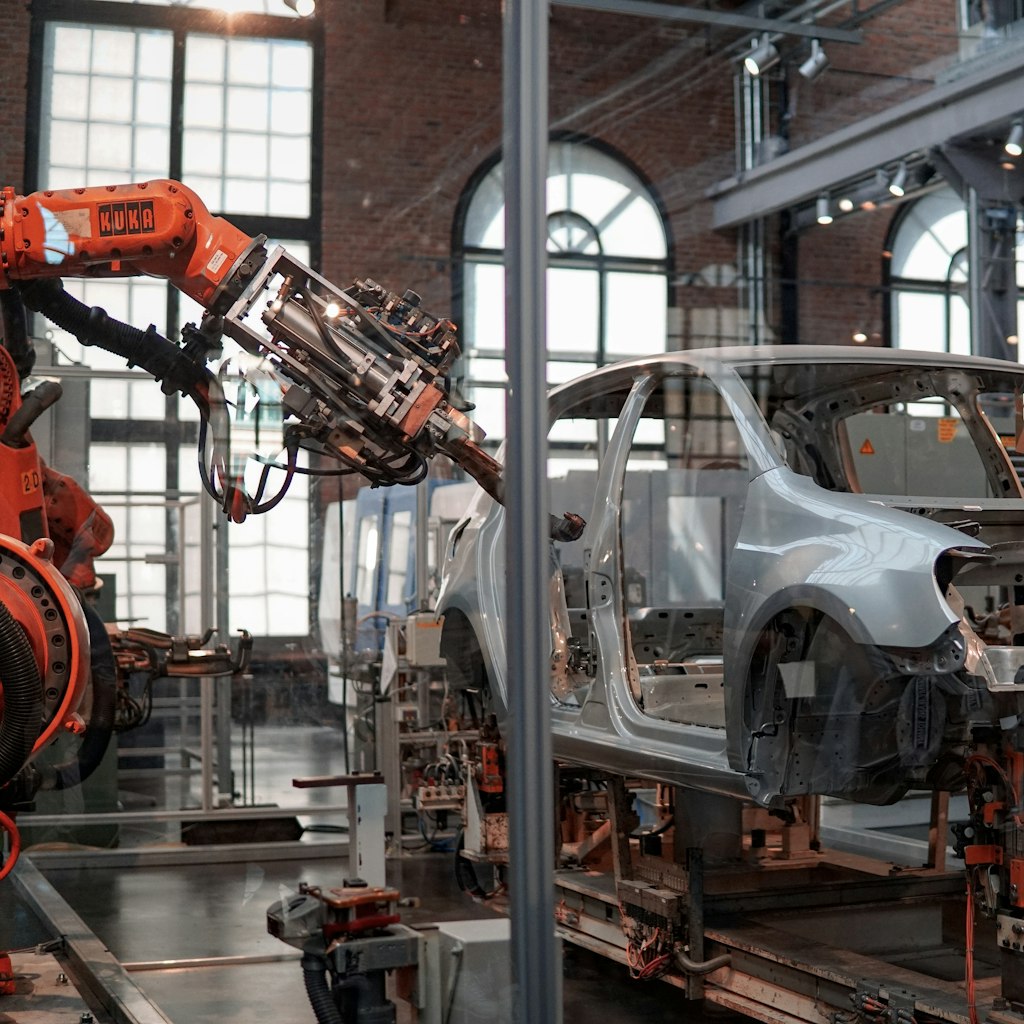 Robotic arms on an automotive assembly line